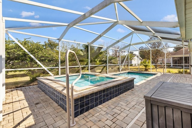 view of swimming pool featuring an in ground hot tub, glass enclosure, and a patio area