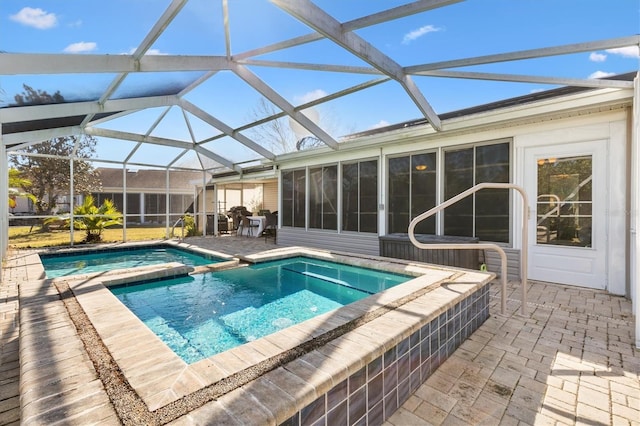 view of pool with a patio, a sunroom, and glass enclosure