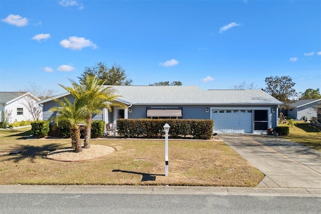 ranch-style home featuring a garage and a front lawn