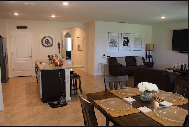 dining room featuring light tile patterned floors and sink