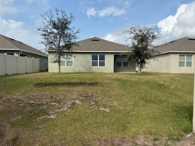 back of property with a lawn