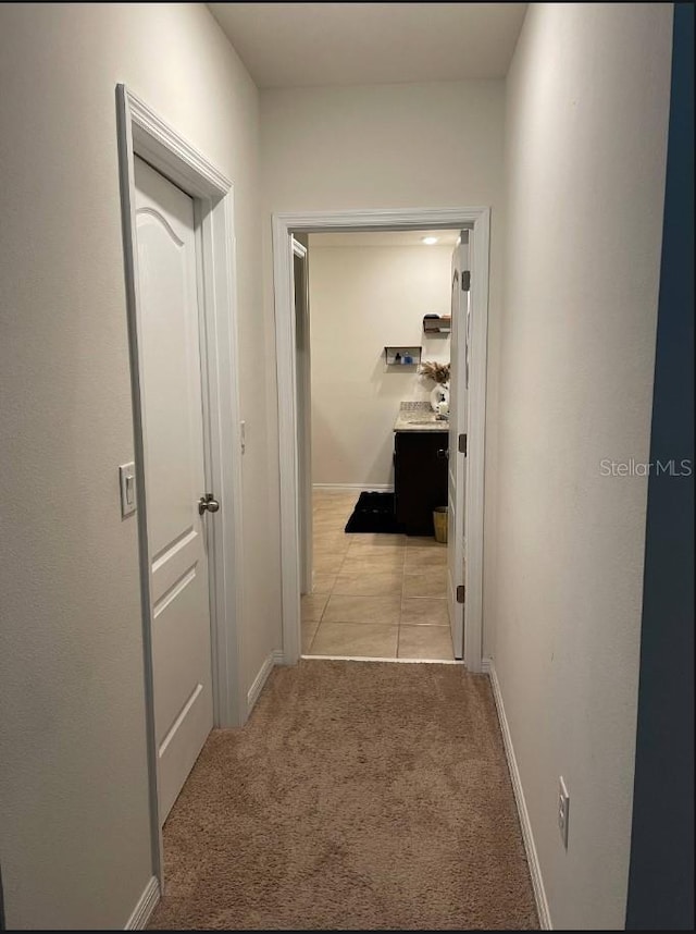 hallway with light colored carpet