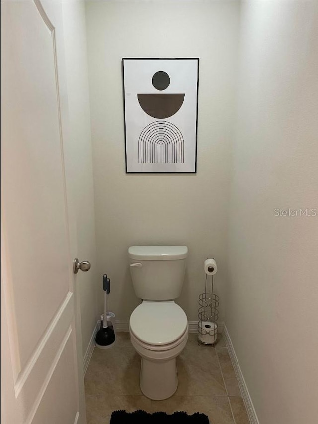 bathroom featuring tile patterned flooring and toilet