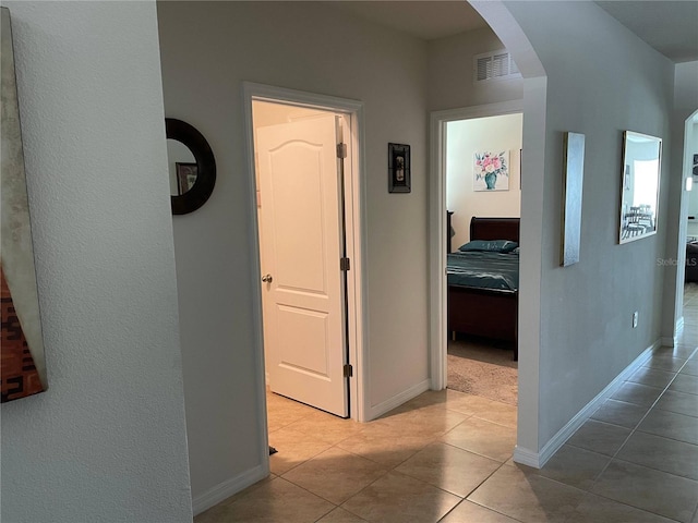 hall featuring light tile patterned floors