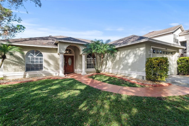 view of front of home featuring a garage and a front lawn