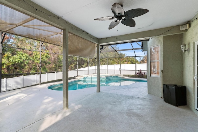 view of swimming pool with ceiling fan, a lanai, and a patio area