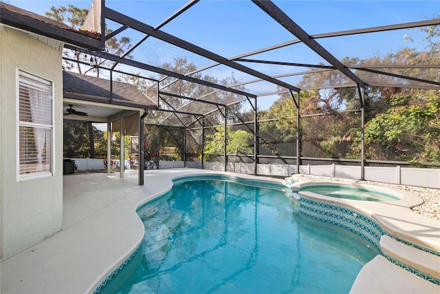 view of swimming pool featuring an in ground hot tub, a lanai, and a patio area