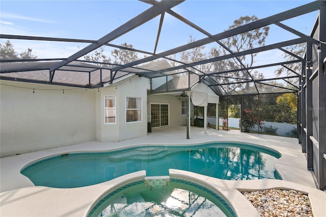 view of swimming pool featuring an in ground hot tub, a lanai, and a patio area