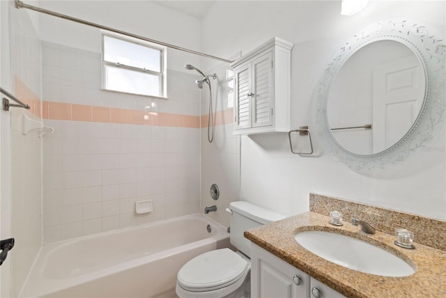 full bathroom with vanity, tiled shower / bath combo, and toilet