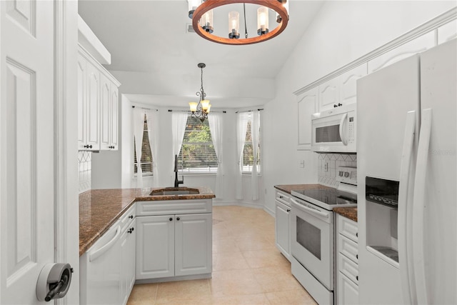 kitchen featuring sink, white appliances, an inviting chandelier, white cabinets, and decorative light fixtures