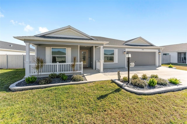 ranch-style house featuring a porch, a garage, and a front lawn