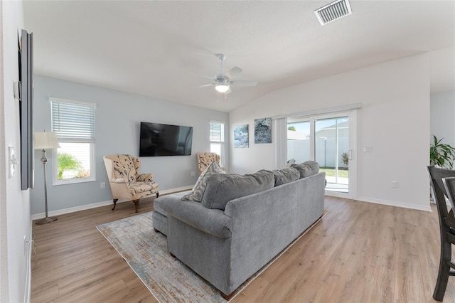 living room featuring lofted ceiling, light hardwood / wood-style flooring, and ceiling fan