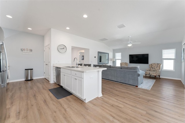 kitchen with sink, white cabinetry, dishwasher, an island with sink, and light hardwood / wood-style floors