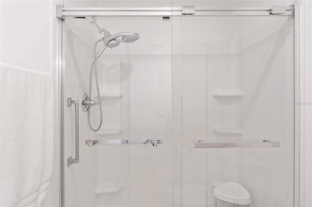 bathroom with a shower with door