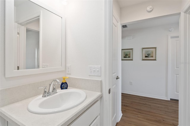 bathroom featuring vanity and wood-type flooring