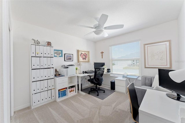 carpeted office featuring ceiling fan