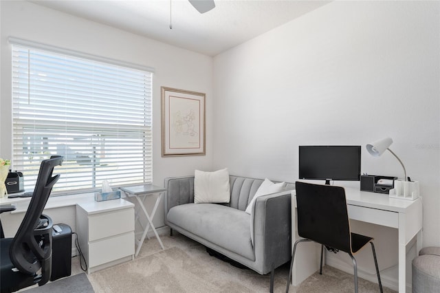 carpeted office space with ceiling fan