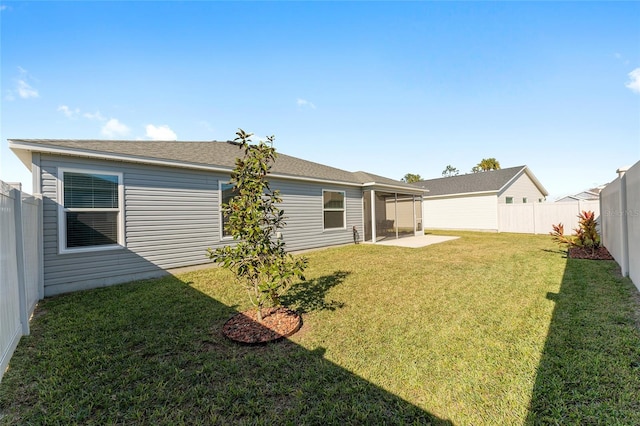 rear view of property with a yard and a patio