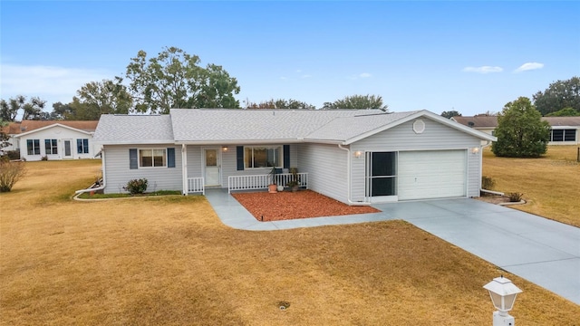 ranch-style home featuring a garage, a front yard, and a porch