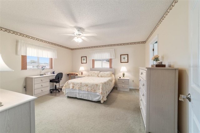 carpeted bedroom with a textured ceiling and ceiling fan