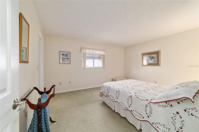 carpeted bedroom featuring a textured ceiling