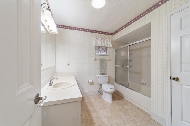 full bathroom with vanity, a textured ceiling, shower / bath combination with glass door, and toilet