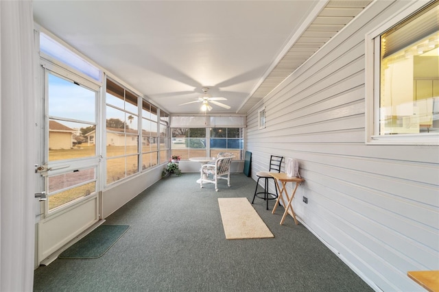 sunroom / solarium with a wealth of natural light and ceiling fan