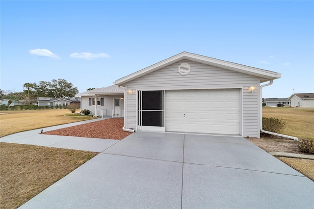 ranch-style house featuring a garage, a front yard, and a porch