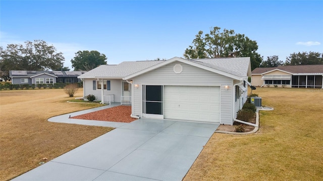 ranch-style house with central AC, a garage, and a front lawn