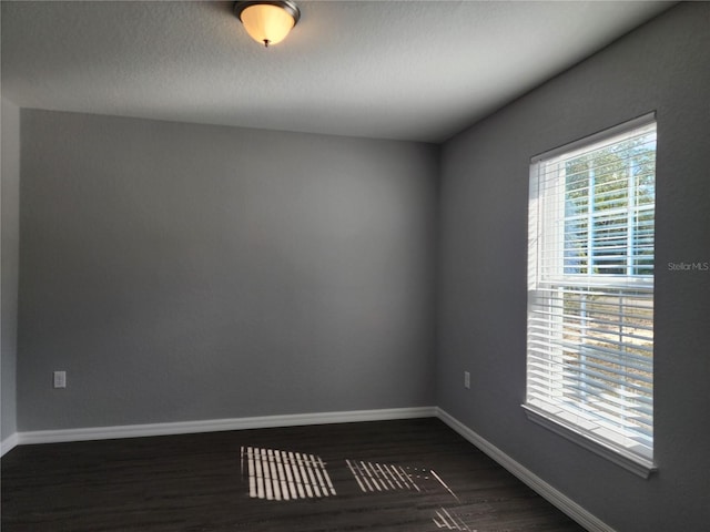 unfurnished room featuring dark hardwood / wood-style floors