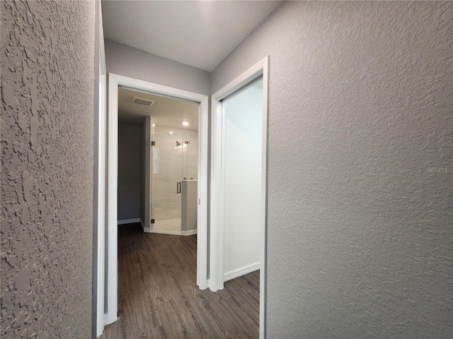 hallway with dark hardwood / wood-style flooring