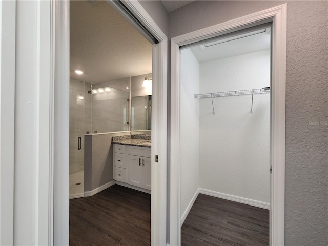 bathroom with vanity, hardwood / wood-style floors, and walk in shower