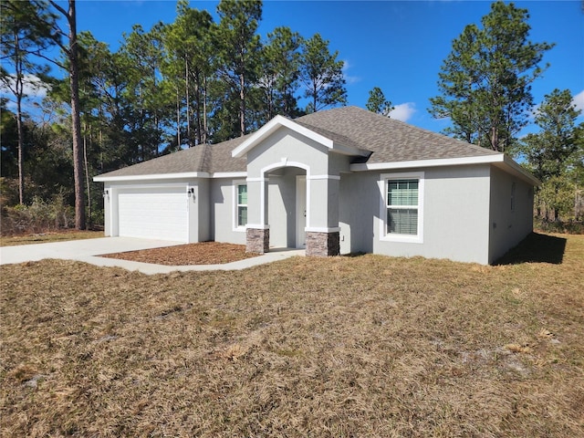 view of front of property with a garage and a front yard