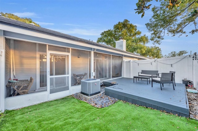 wooden terrace with central AC, a sunroom, and a lawn