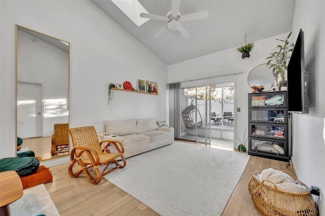 living room featuring hardwood / wood-style flooring, ceiling fan, and high vaulted ceiling