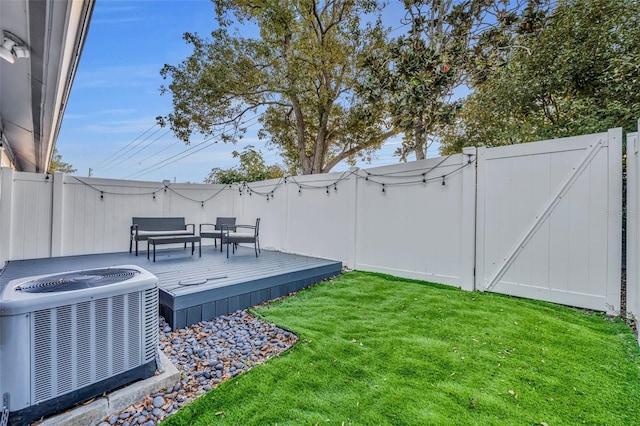 view of yard featuring a wooden deck and central AC