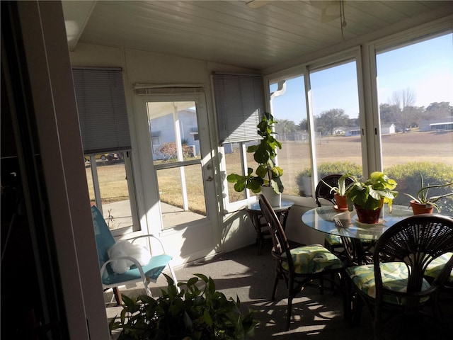 sunroom / solarium featuring vaulted ceiling and a wealth of natural light