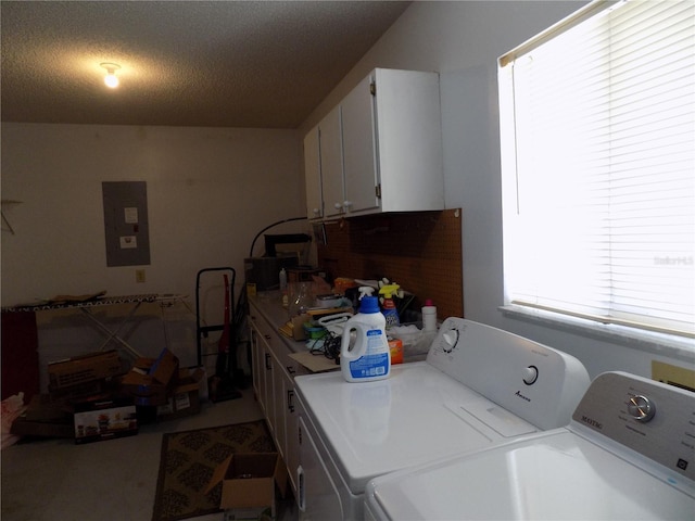 clothes washing area featuring cabinets, electric panel, separate washer and dryer, and a textured ceiling