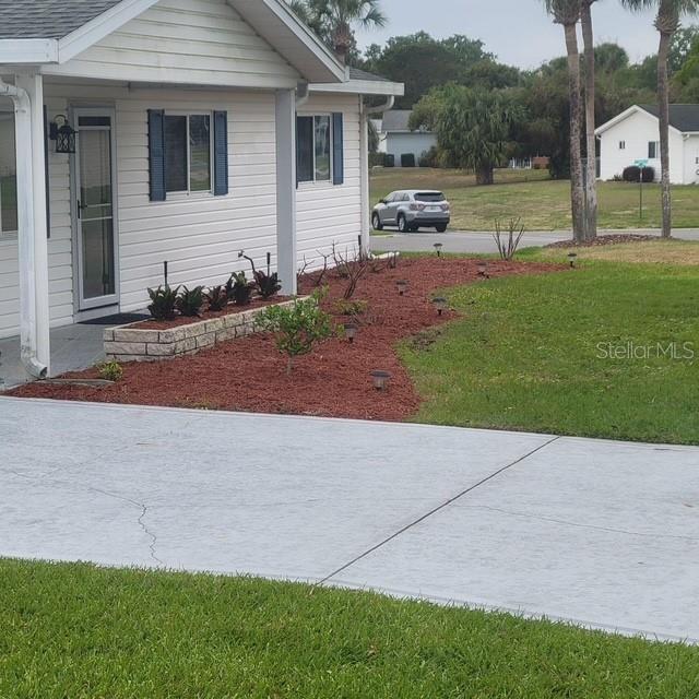 view of side of property featuring a yard