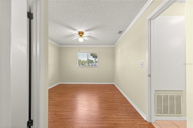 17664 SE 105th Ter, Summerfield, FL 34491 - empty room featuring wood finished floors, crown molding, ceiling fan, a textured ceiling, and baseboards