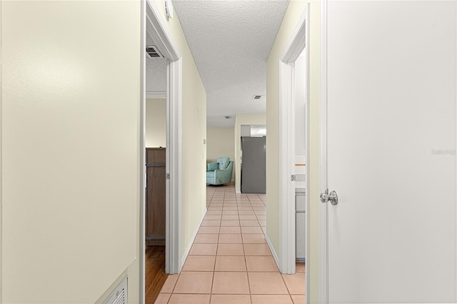 17664 SE 105th Ter, Summerfield, FL 34491 - hall featuring light tile patterned floors and a textured ceiling