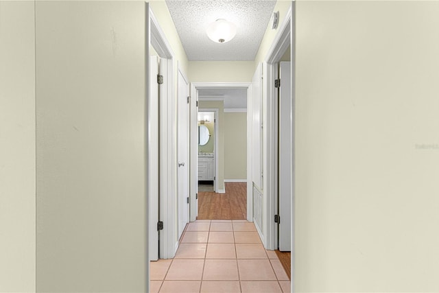 17664 SE 105th Ter, Summerfield, FL 34491 - hallway featuring a textured ceiling and light tile patterned flooring