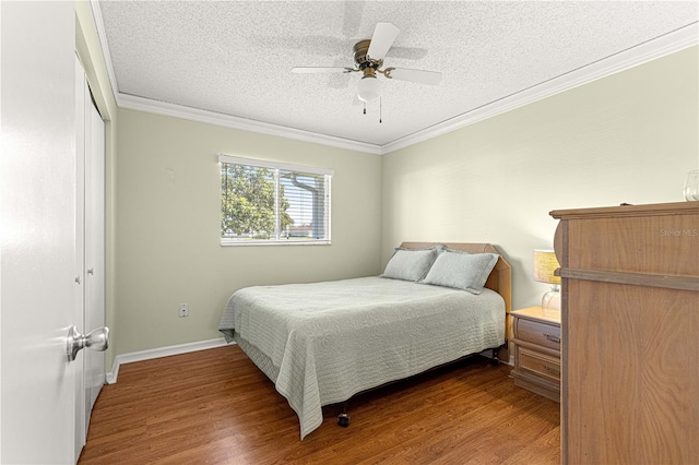 17664 SE 105th Ter, Summerfield, FL 34491 - bedroom with wood finished floors, ornamental molding, a textured ceiling, a closet, and ceiling fan