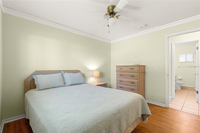 17664 SE 105th Ter, Summerfield, FL 34491 - bedroom with ornamental molding, wood finished floors, a textured ceiling, baseboards, and ceiling fan