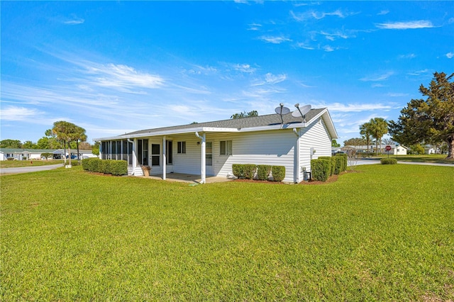 17664 SE 105th Ter, Summerfield, FL 34491 - rear view of house featuring a sunroom and a lawn