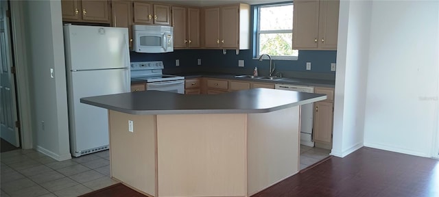 kitchen featuring sink, white appliances, tile patterned flooring, a center island, and light brown cabinets