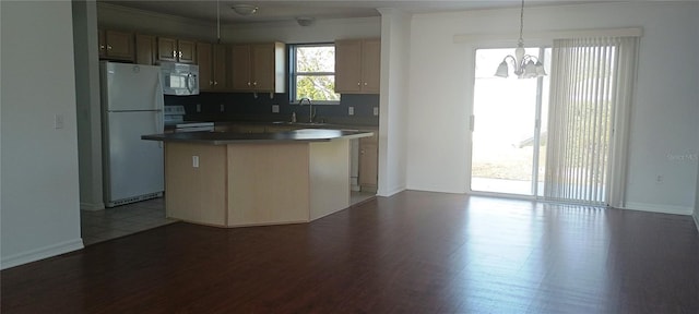 kitchen featuring sink, range, decorative light fixtures, a kitchen island, and white fridge