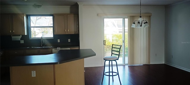 kitchen with a healthy amount of sunlight, sink, a notable chandelier, and decorative light fixtures