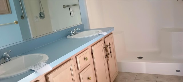 bathroom with tile patterned flooring, vanity, and a shower