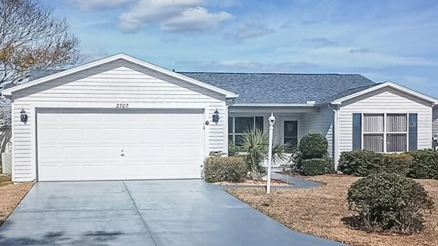 single story home with driveway and an attached garage